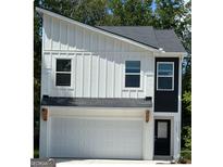 Modern two-story home featuring white vertical siding and a garage at 4858 Station Ln # 22, Union City, GA 30349