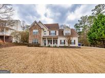 Charming two-story home featuring a stone facade, inviting front porch, and well-manicured lawn at 270 Sturgess Run, Sharpsburg, GA 30277