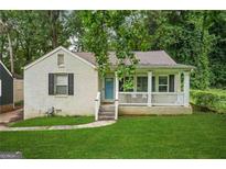 Charming front exterior of a brick home, with a welcoming front porch and lush green lawn at 1273 Boulevard Lorraine Sw, Atlanta, GA 30311