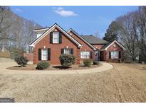 Charming brick home featuring manicured landscaping and a welcoming front entrance at 1855 Wakefield Trce, Mcdonough, GA 30252