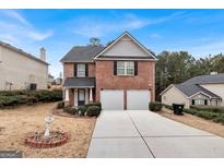 Charming two-story brick home with a well-maintained front yard and two-car garage at 5734 Union Pointe Dr, Union City, GA 30291