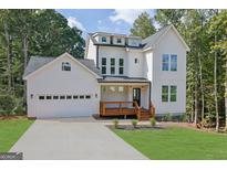 Beautiful two-story home with a spacious driveway and a charming front porch at 553 Sommersby Dr, Dallas, GA 30157