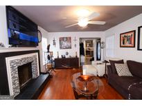 Inviting living room featuring a fireplace, hardwood floors, and comfortable seating at 1899 Se Cooper Landing Se Dr, Smyrna, GA 30080