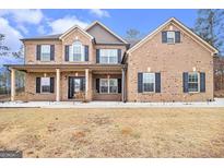 Charming two-story brick home featuring a covered front porch and well-maintained landscaping at 224 Jester Ct, Mcdonough, GA 30252