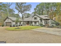 A charming home featuring a circular driveway and well-manicured landscaping at 375 Darren Dr, Fayetteville, GA 30215