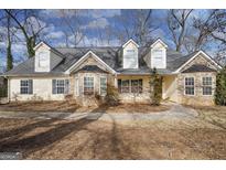 Charming single-Gathering home with stone accents and dormer windows, set amidst mature trees at 603 Honey Creek Rd, Mcdonough, GA 30252