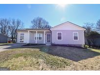 Charming single-story home with light grey siding, modern garage door and a well-manicured front lawn at 242 Deerfield Dr, Jonesboro, GA 30238