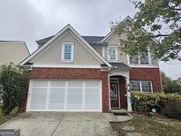 Charming two-story home with a red brick facade and attached two-car garage at 1821 Durwood Ln, Duluth, GA 30096