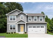 Charming two-story home with gray siding, white trim, yellow front door, and a two-car garage at 812 Sweet Pine Brk, Stone Mountain, GA 30087