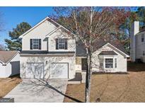 Charming two-story home with a well-maintained lawn, a two-car garage, and a classic suburban appeal at 2391 Wellborn Hills Ct, Lithonia, GA 30058
