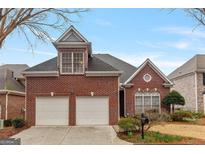 Charming brick home with a two-car garage and well-maintained front yard at 6275 Glen Oaks Ln, Atlanta, GA 30328