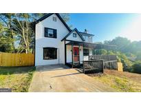 Charming two-story home with a welcoming porch and a bright red front door at 3824 Charlotte Dr, Rex, GA 30273