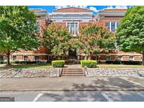 Beautiful brick building with manicured landscaping and mature trees lining the front at 978 N Avenue Ne 307, Atlanta, GA 30306