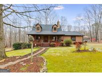 Charming two-story home with a beautifully landscaped front yard and inviting front porch at 630 Stoney Point Rd, Bowdon, GA 30108