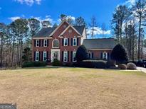 Charming two-story brick home with black shutters and a well-maintained front yard at 175 Monarch Dr, Peachtree City, GA 30269