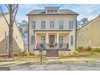 Charming two-story home with a welcoming front porch, black accents, and an American flag at 120 Middleton Dr, Peachtree City, GA 30269