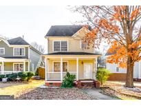 Charming two-story home with a cozy front porch and a well-maintained yard at 1020 Sw High Point Cv, Atlanta, GA 30315