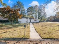 Charming single-story home with well-maintained lawn and walkway to entrance at 3044 Sunset Ln, East Point, GA 30344