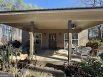 Inviting front porch with ceiling fans, perfect for outdoor relaxation and enjoying peaceful views at 2520 Hollonville Rd, Brooks, GA 30205