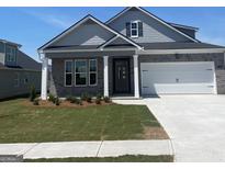 Charming one-story brick home with a manicured lawn and attached garage at 745 Myrica Ave, Locust Grove, GA 30248