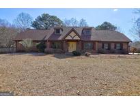 Charming home with a unique Tudor-style facade and well-maintained landscaping at 335 Castlewood Rd, Tyrone, GA 30290