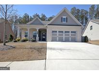 Charming single-story home featuring a three-car garage and an inviting covered front porch at 625 Timberbrook Dr, Sharpsburg, GA 30277