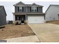 Two-story gray home with a two-car garage, covered entry, and nicely manicured lawn at 456 Prescott Way, Villa Rica, GA 30180