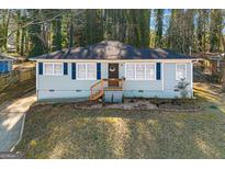 Charming single-story home with blue shutters, a well-manicured lawn, and a cozy front porch at 3723 Glenwood Rd, Decatur, GA 30032