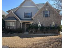 Charming brick home with a symmetrical facade, a manicured lawn, and a welcoming entryway at 1186 Diamond Xing, Mcdonough, GA 30252