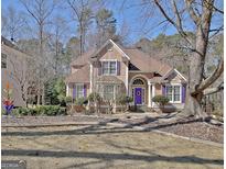 Charming two-story home with a manicured lawn and purple shutters adding a pop of color at 123 Fielding Rdg, Peachtree City, GA 30269