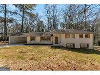 Charming brick home featuring a spacious carport and complementary shutters at 2598 Lake Shore, College Park, GA 30337