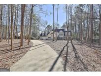 Traditional two story home featuring a long driveway surrounded by mature trees at 114 Oak Ridge Dr, Sharpsburg, GA 30277