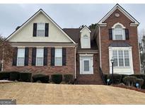 Charming brick two-story home with traditional black shutters and well-manicured landscaping at 3223 Thornecreek Dr, Douglasville, GA 30135