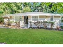 Charming single-story home with a lush green lawn and mature trees at 2804 Mitchell Dr, Decatur, GA 30032