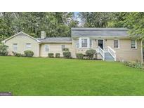 Charming home with a lush green lawn and well-maintained landscaping at 2430 Fern Valley Ct, East Point, GA 30344