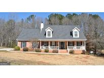 Charming brick home with a welcoming front porch and well-maintained lawn at 500 Hayfield Ct, Locust Grove, GA 30248