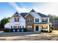 Charming two-story home featuring stone accents, white siding, and lush landscaping at 45 George Wynn Rd, Palmetto, GA 30268