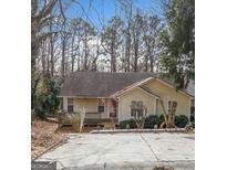 Charming one-story home with mature trees and a front porch, perfect for enjoying the outdoors at 5119 Hill Farm Ne Dr, Woodstock, GA 30188
