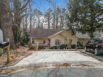 Charming single-story home with a welcoming front yard and a driveway with ample parking space at 5119 Hill Farm Ne Dr, Woodstock, GA 30188