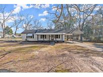 Charming single-story home featuring a covered porch and attached carport at 5211 Old Monticello Se St, Covington, GA 30014