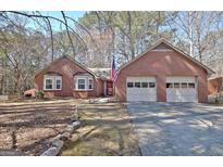 Charming brick home with attached two-car garage and well-manicured lawn, located on a tree lined street at 300 Planceer Pl, Peachtree City, GA 30269