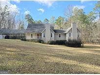 Charming traditional home with manicured lawn, inviting front porch, and covered parking at 110 Kari Glen Way, Fayetteville, GA 30215