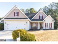 Charming single-Gathering home featuring a well-manicured lawn and a two-car garage at 104 Summer Chase, Carrollton, GA 30116