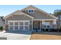 Charming single-story home featuring a two-car garage, covered porch, and neutral siding in a well-maintained community at 645 Timberbrook Dr, Sharpsburg, GA 30277