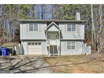 Charming two-story home featuring a garage and traditional architectural details at 5938 Rock Ct, Union City, GA 30291