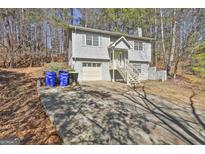 Two-story home features a front-facing garage and charming stairs leading to the front entrance at 5938 Rock Ct, Union City, GA 30291