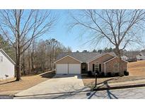 Charming one-story home featuring a two-car garage and manicured landscaping at 3577 N Winds Trl, Douglasville, GA 30135