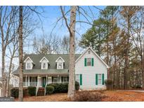Charming two-story home featuring a welcoming front porch with green shutters and a well-maintained front yard at 495 N Oakland Cir, Mcdonough, GA 30253