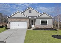 Charming single-story home with brick and gray siding, complemented by a well-manicured lawn at 3382 Arabian Farm Ln, Dacula, GA 30019