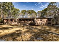 Charming single story home with brick exterior, red shutters, and lush green trees at 160 Pine Trail Rd, Fayetteville, GA 30214